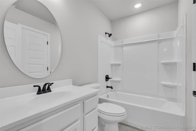 bathroom featuring toilet, shower / washtub combination, and vanity