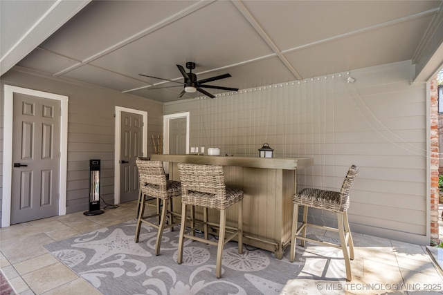 view of patio featuring outdoor dry bar and a ceiling fan