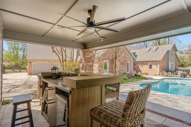 view of patio featuring a ceiling fan, outdoor dry bar, and a fenced in pool