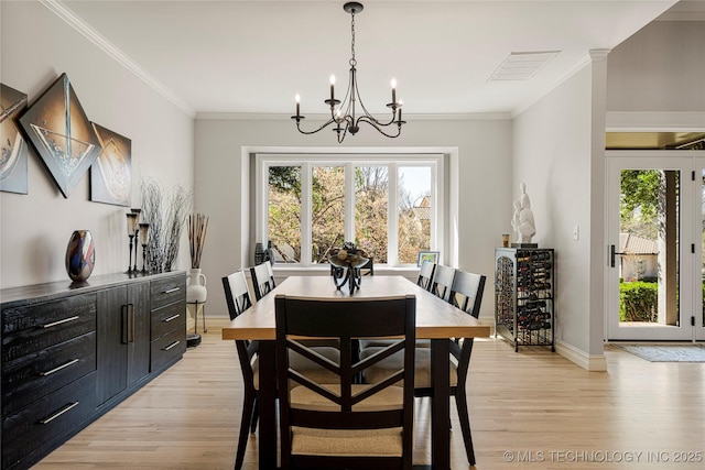 dining room with light wood-type flooring, a wealth of natural light, and visible vents