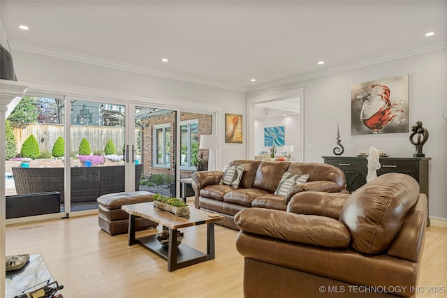 living room with light wood-style flooring, ornamental molding, and recessed lighting