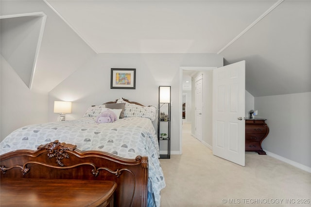 bedroom with lofted ceiling, light colored carpet, and baseboards