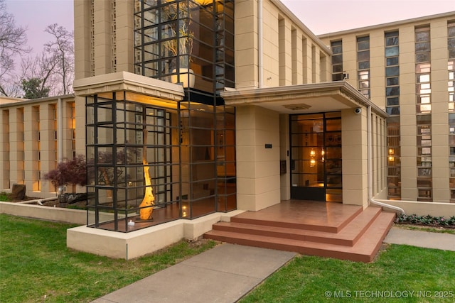 view of exterior entry at dusk