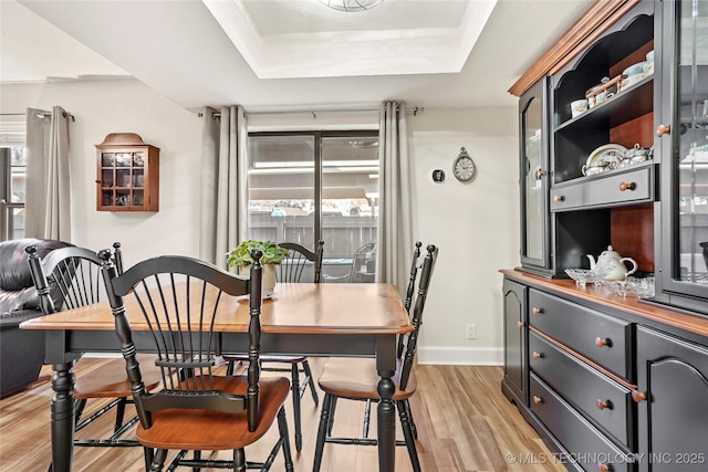 9114 S Urbana Ave Unit 9C, Tulsa, OK 74137 - dining area with light wood-style floors, a tray ceiling, and baseboards