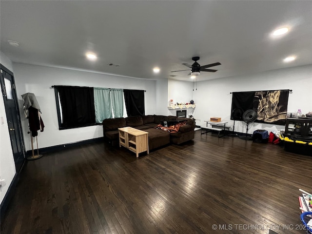 living area featuring dark wood-style floors, recessed lighting, visible vents, and a ceiling fan