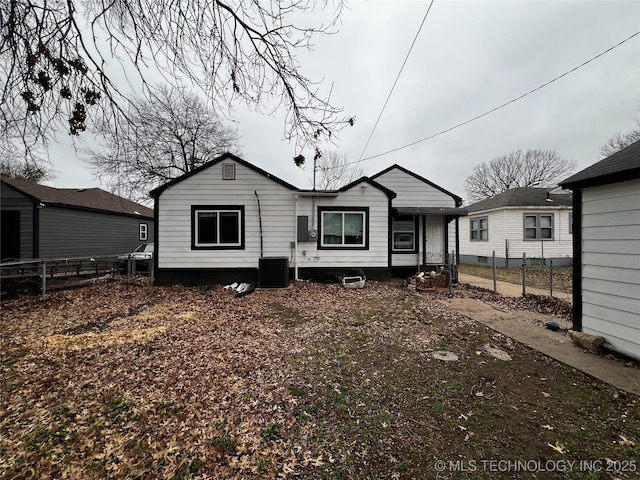 back of house with central AC unit and fence