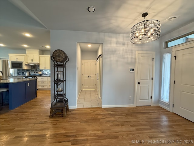 1825 E 45th Pl, Sand Springs, OK 74063 - foyer entrance featuring a notable chandelier, baseboards, recessed lighting, light wood-style flooring, and visible vents