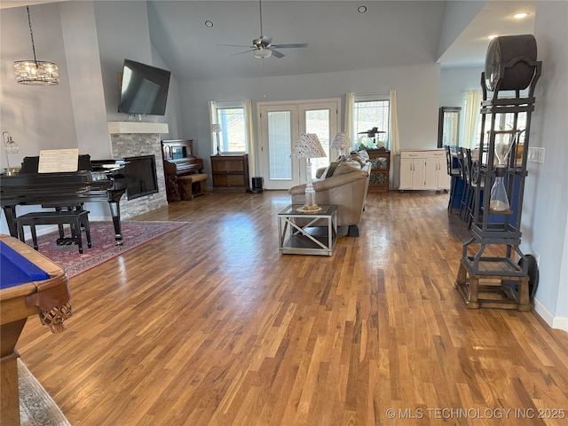 1825 E 45th Pl, Sand Springs, OK 74063 - living room with light wood-style floors, high vaulted ceiling, ceiling fan, a fireplace, and baseboards