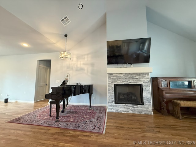 1825 E 45th Pl, Sand Springs, OK 74063 - living room featuring wood finished floors, baseboards, vaulted ceiling, and visible vents