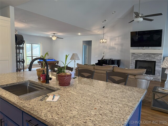 1825 E 45th Pl, Sand Springs, OK 74063 - kitchen featuring visible vents, a sink, open floor plan, a ceiling fan, and blue cabinetry