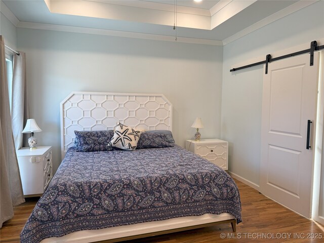 1825 E 45th Pl, Sand Springs, OK 74063 - bedroom with crown molding, a tray ceiling, a barn door, and wood finished floors