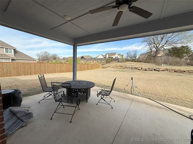 1825 E 45th Pl, Sand Springs, OK 74063 - view of patio with outdoor dining area, fence, and ceiling fan