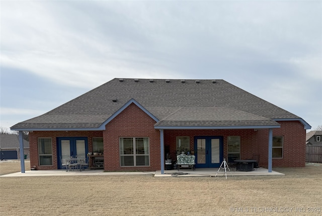 1825 E 45th Pl, Sand Springs, OK 74063 - back of property featuring brick siding, a patio area, roof with shingles, and french doors