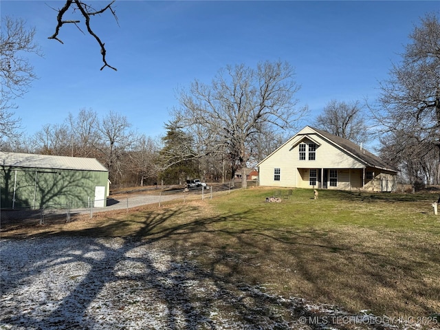 view of yard with an outbuilding and fence