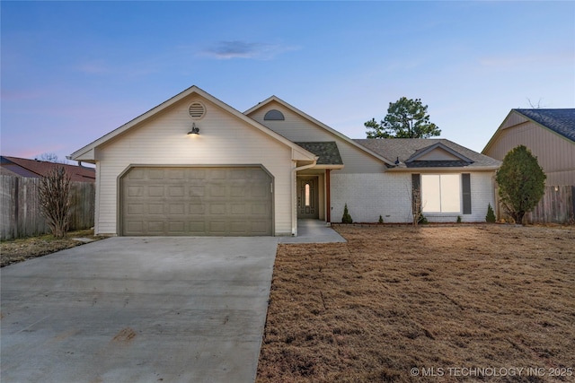 ranch-style home with a garage, concrete driveway, brick siding, and fence