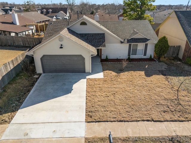 ranch-style house featuring an attached garage, fence, concrete driveway, roof with shingles, and a residential view