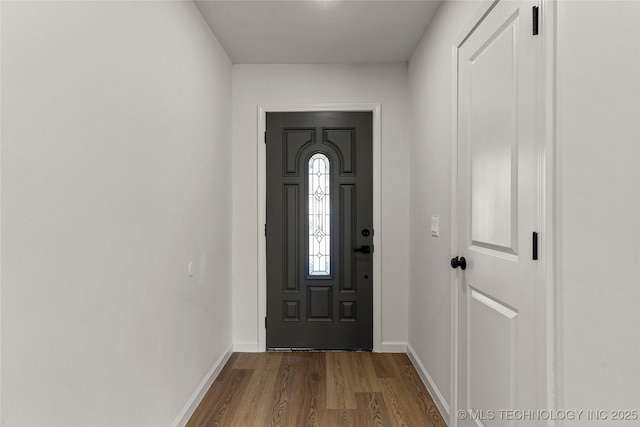 foyer entrance featuring baseboards and wood finished floors