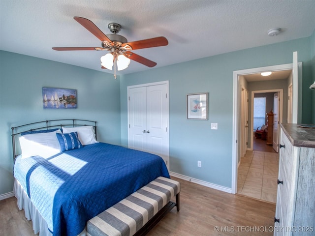 bedroom featuring a closet, baseboards, and wood finished floors