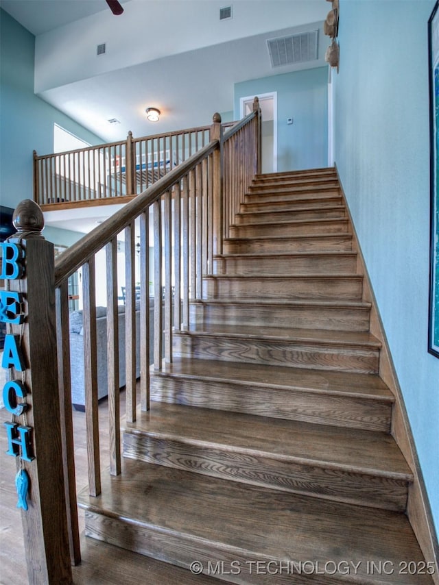 stairway with ceiling fan, plenty of natural light, and visible vents