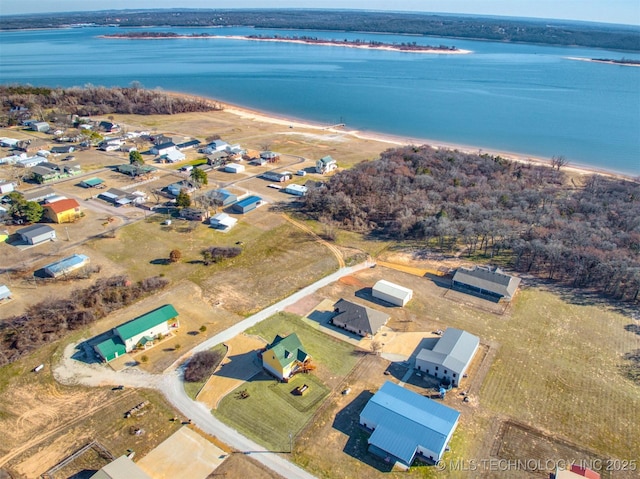 birds eye view of property with a view of the beach and a water view