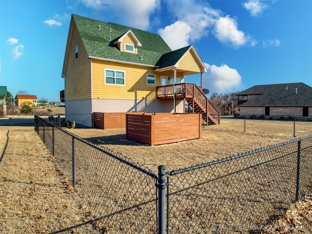 view of jungle gym with a deck, fence, and stairway