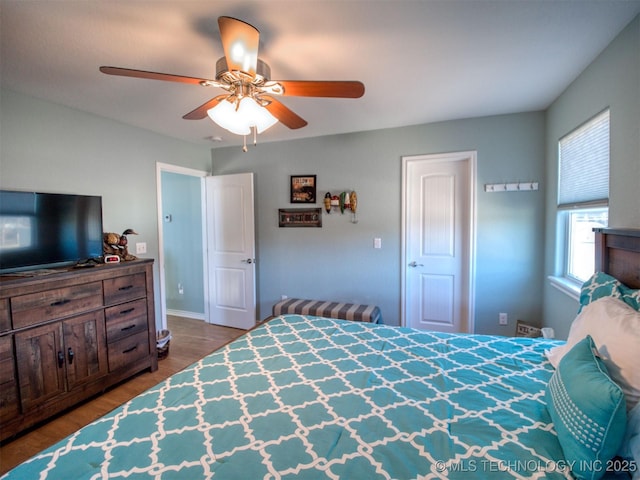 bedroom with a ceiling fan and wood finished floors