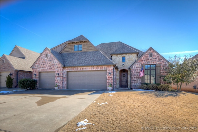 view of front facade with an attached garage, brick siding, driveway, stone siding, and roof with shingles