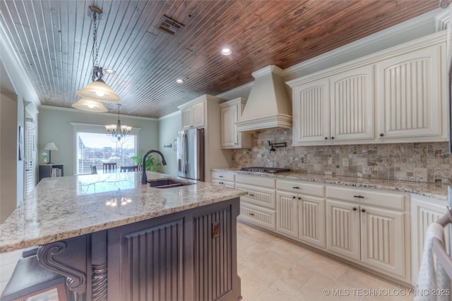 kitchen featuring stainless steel appliances, a kitchen island with sink, hanging light fixtures, and custom exhaust hood