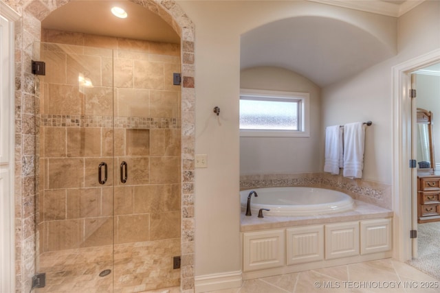 bathroom with a stall shower, tile patterned flooring, a garden tub, and crown molding