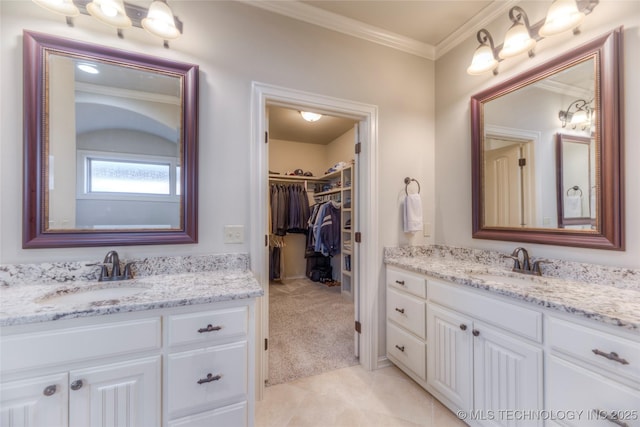 full bath featuring ornamental molding, a walk in closet, vanity, and tile patterned floors