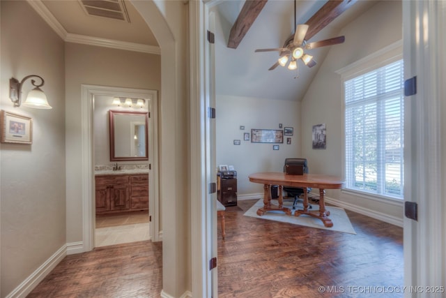 office space with arched walkways, lofted ceiling with beams, wood finished floors, and visible vents