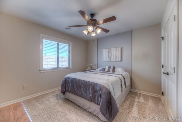 bedroom featuring a ceiling fan, visible vents, and baseboards