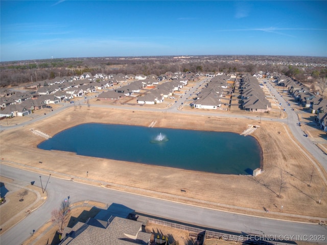 birds eye view of property with a water view and a residential view