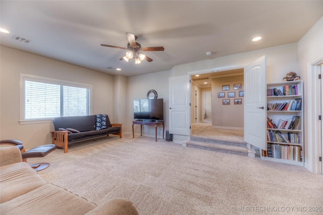 living area featuring light carpet, ceiling fan, visible vents, and recessed lighting