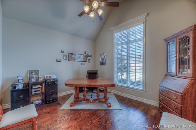 office area featuring dark wood-style floors, lofted ceiling, baseboards, and a ceiling fan