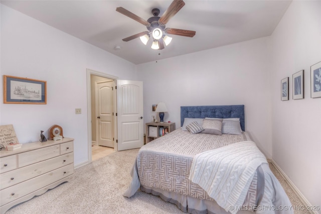 bedroom featuring light carpet, ceiling fan, and baseboards