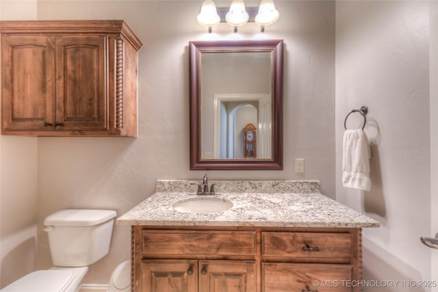 bathroom with toilet and vanity