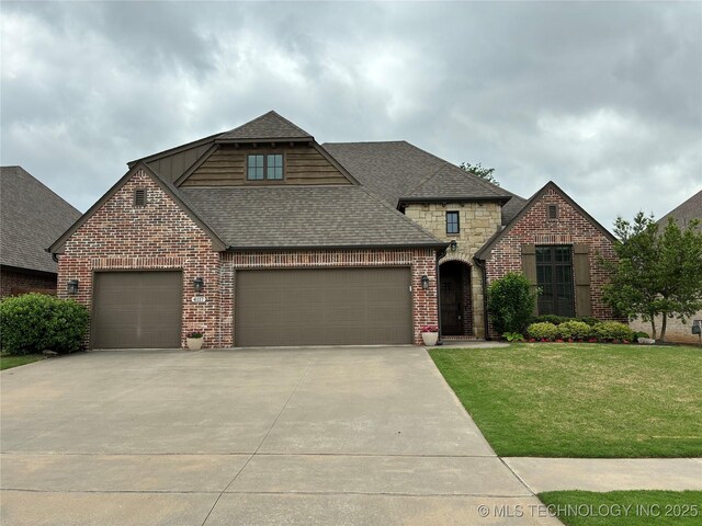 view of front facade with roof with shingles, an attached garage, brick siding, concrete driveway, and a front yard