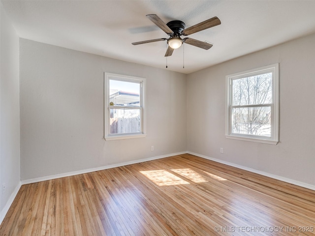 empty room with light wood-style flooring and baseboards