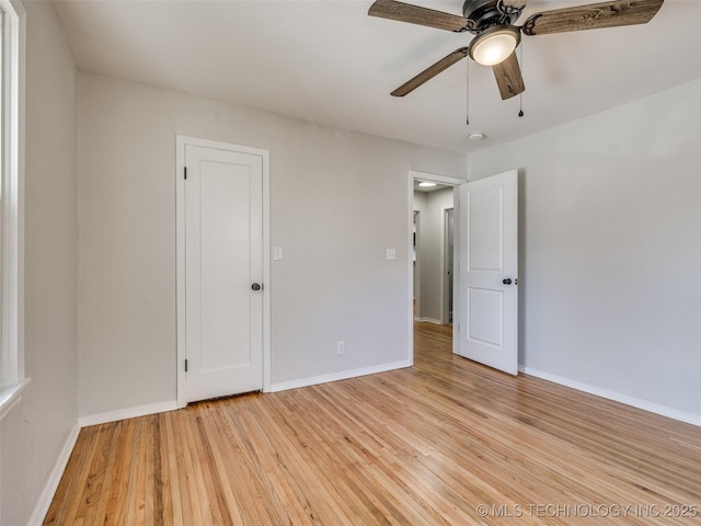 spare room with light wood-style floors and baseboards