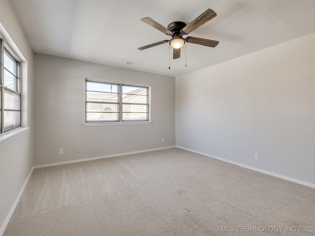 unfurnished room with carpet, plenty of natural light, and baseboards