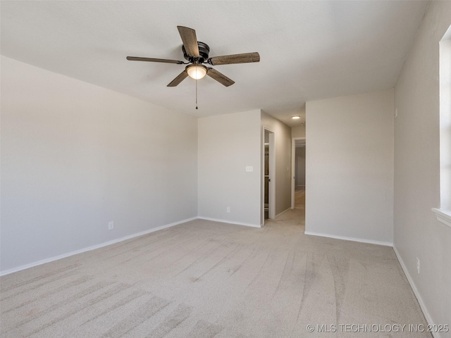 unfurnished room with light carpet, baseboards, and a ceiling fan