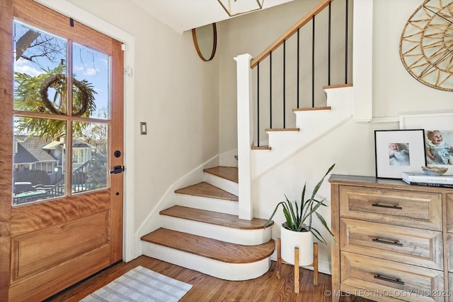 foyer entrance with stairs and dark wood-type flooring