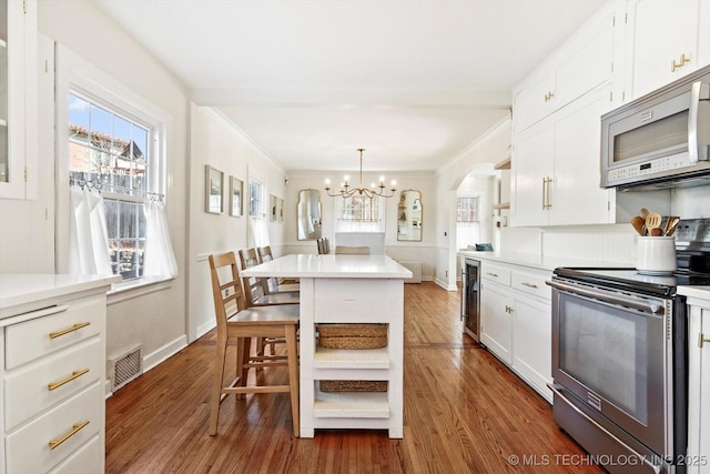 kitchen with open shelves, visible vents, light countertops, appliances with stainless steel finishes, and white cabinetry