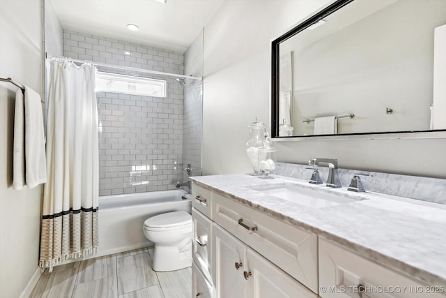 full bath featuring toilet, shower / bath combination with curtain, and vanity