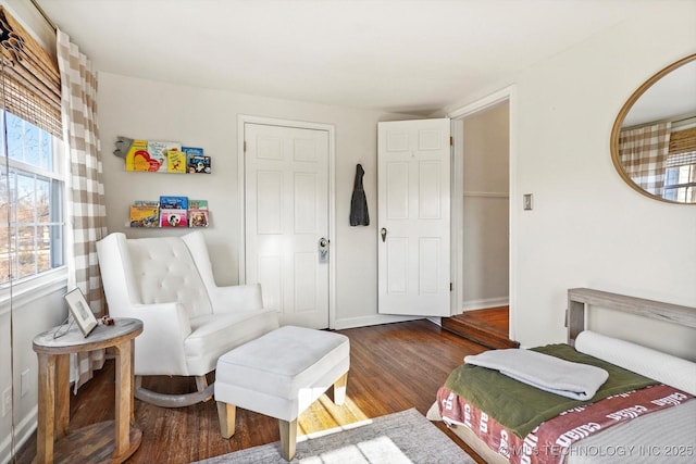 bedroom featuring dark wood finished floors and baseboards