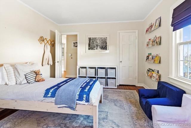 bedroom featuring dark wood-style floors, multiple windows, and crown molding