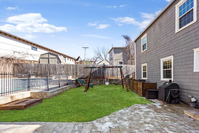 view of yard with a patio area, a fenced backyard, and a swimming pool