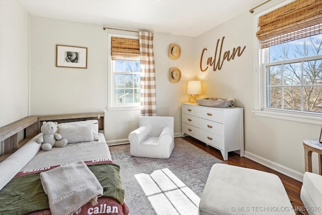 bedroom with dark wood-style flooring and baseboards