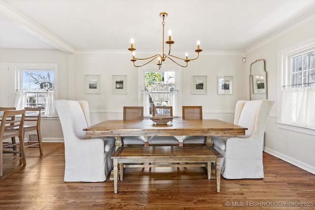 dining area featuring baseboards, dark wood finished floors, and crown molding